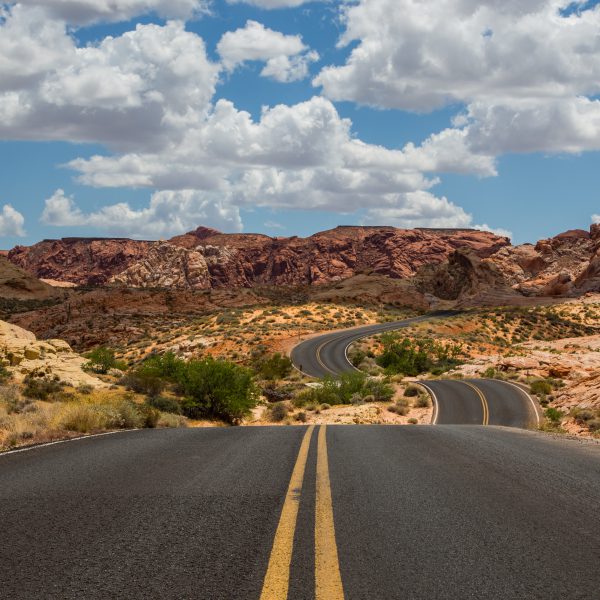 Difficult winding two-way road leading to beautiful desert mountain destination